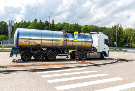 Moscow, Russia - July 12, 2022: Gasoline tanker, Oil trailer, truck on highway. Automotive fuel tanker shipping fuelのeditorial素材