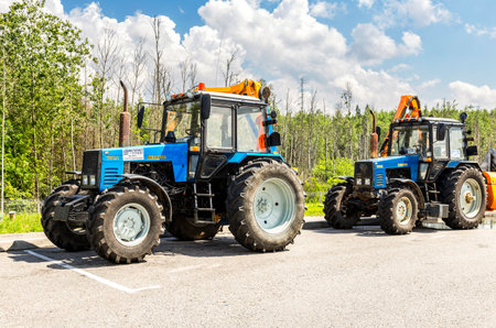 Moscow, Russia - July 12, 2022: Road service wheeled tractors parked in the car park on the toll highway m11のeditorial素材