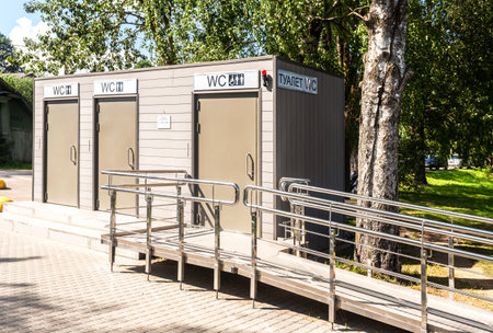 Moscow, Russia - August 6, 2022: Exterior of modular cabin of modern public toilet at the city street. Lavatory with WC sign, accessible for the disabledのeditorial素材