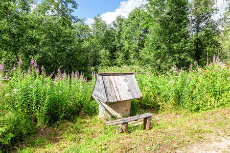 Traditional wooden water well at the countryside in summer sunny dayの写真素材