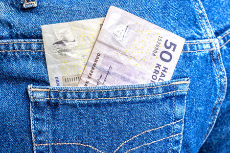 Danish kronor banknotes sticking out of the jeans pocket. Money in the pocketの写真素材