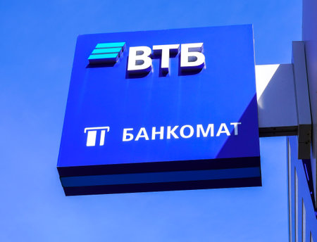 Samara, Russia - April 12, 2023: Signboard with logo of the Russian VTB bank against the blue sky. VTB bank is one of the largest Russian banks. Text in english: Cash dispenserのeditorial素材