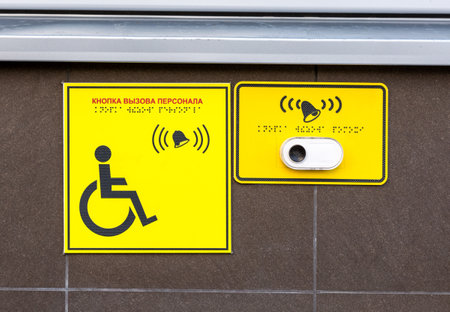 Signage plate for disabled people with a call button and braille inscription. Text in english: Call button personnelの写真素材