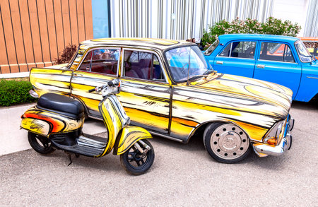 Samara, Russia - May 14, 2023: Vintage soviet Moskvich-412 vehicle and Honda Giorno scooter at a...