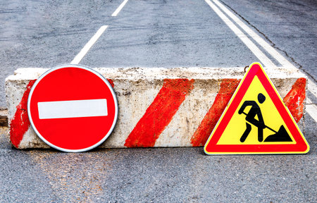 Road works sign at the city street. Carrying out construction and repair work in the cityの写真素材