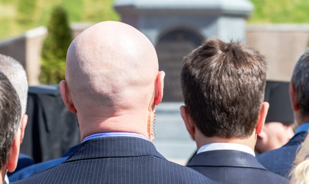 Secret service agent (security guard) with earpiece, behind view. Selective focus