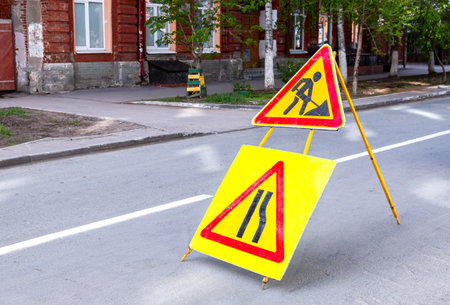 Road works sign at the city street. Carrying out construction and repair work in the cityの写真素材