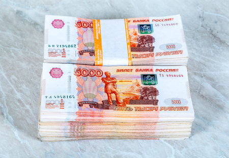 Stacks of five thousandths banknotes of Russian roubles close up