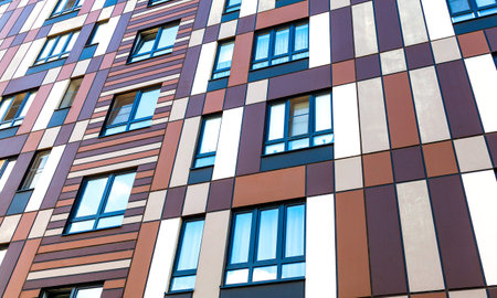 Facade fragment of new bright colorful modern residential building