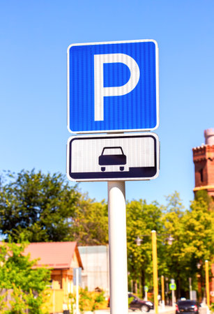 Parking traffic sign against the blurred urban background in summerの写真素材