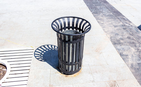 Garbage metal container for waste and trash at the city street in summerの写真素材