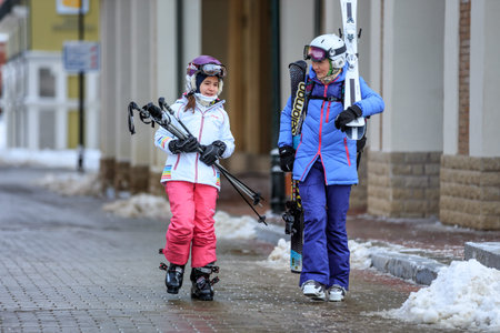 Sochi, Russia - January 9, 2015: Ski slopes in Gorky Gorod winter resort can be hosting skiers and snowboard riders during 6 months a year. Mother and daughter went out for a ski rideのeditorial素材