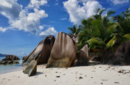 Scenic landscape of sunny tropical Anse Source D'Argent Beach on La Digue Island, Seychelles, with white sand, rocks and blue sky. Idyllic scenery of seaside resort. Exotic travel destination.の写真素材
