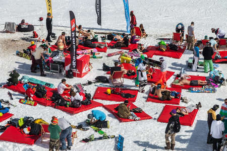 Sochi, Russia - March 25, 2014: Quiksilver NewStar Camp is winter mountain sports and entertainment activity for skiers and snowboarders. Many people chill out relaxing apres ski on snow in open airのeditorial素材