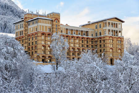 Sochi, Russia - January 9, 2015: Modern and fashionable Novotel Resort Krasnaya Polyana Sochi Hotel is located on snowy mountain slope and surrounded by picturesque winter Caucasus Mountains sceneryのeditorial素材