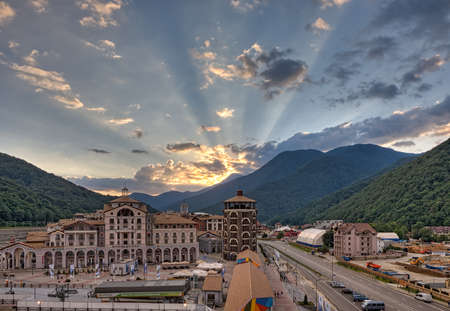 Sochi, Russia - July 31, 2014: Beautiful sunset townscape of modern hotel and apartment buildings of Gorky Gorod mountain ski resort surrounded with green summer mountain forestのeditorial素材