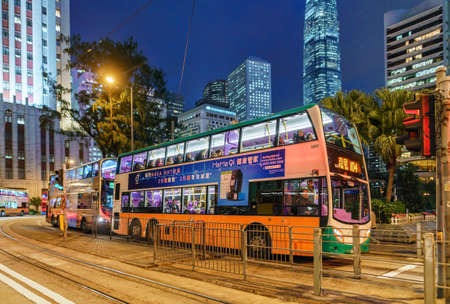 Hong Kong, China - January 12, 2016: Public bus services in Hong Kong are popular with tourists and local citizens. All buses have two levels and move around the whole city. Night cityscape with busesのeditorial素材