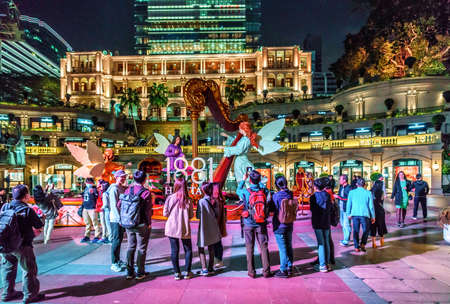 Hong Kong - January 18, 2016: Tourists standing at Christian festive decorations on Chinese New Year celebration by the iconic 1881 Heritage Hotel in Tsim Sha Tsui. Night viewのeditorial素材