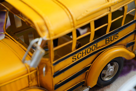Close up miniature metal toy yellow school bus