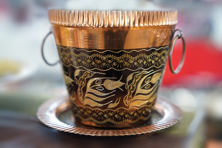 Old copper bucket with handle on blur backgroundの写真素材