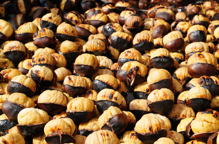 Grilled chestnuts for sale on streetの写真素材