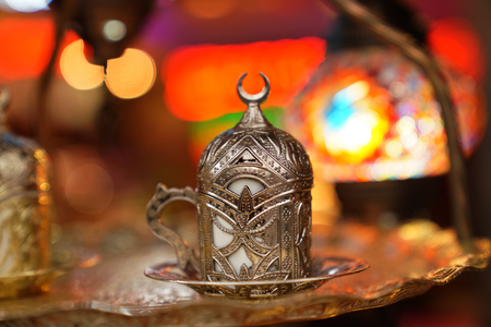 Copper covered Turkish coffee cup set on bright backgroundの写真素材