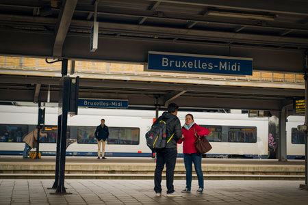 Brussels, Belgium - October 11 2019: Bruxelles Midi station sign and passengers waiting around.