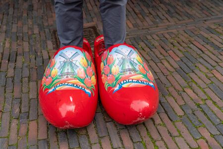 Big clogs with man's leg in Holland. Man try big clogs in Nederland.の写真素材