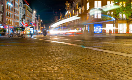 Amsterdam/Holland - October 06 2019: Light trails of cars and buses on  Amsterdam street at night. A taste of travel in the Netherlands. Long exposure.のeditorial素材