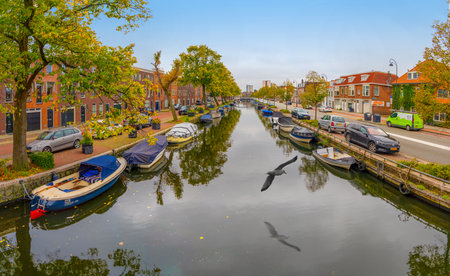 Haarlem/Holland - October 06 2019:   Boats laying in the water. Canals and historical houses.のeditorial素材