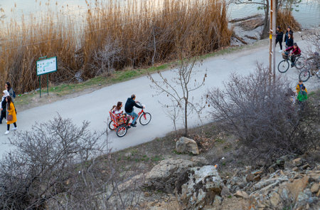 Ankara/Turkey-March 08 2020: Aerial view of people walking and biking on peaceful road along the Lake Eymir, Odtuのeditorial素材