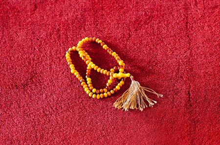 Muslim prayer beads on red carpet in a mosqueの写真素材