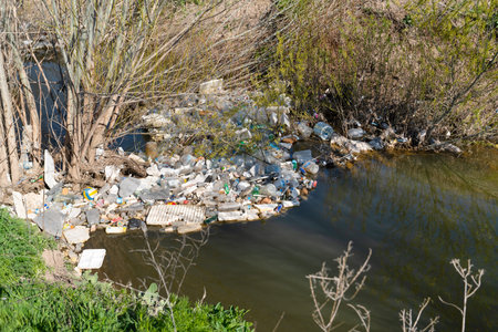 Emirdag/Turkey - April 10 2010: Many plastic waste on the stream causes environmental pollution.