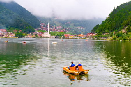Panoramic view of Uzungol which is a tourist attraction in Trabzon, Turkey. The paddle boat on Uzungol.のeditorial素材