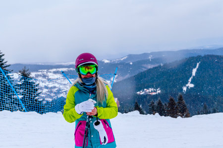 Ilgaz/Turkey- January 19 2020: Happy woman in winter with ski googles on a ski trip holding polesのeditorial素材