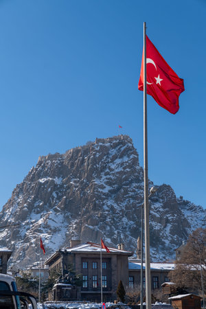 Close up of Afyon Kalesi with Turkish flags