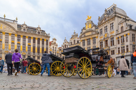 Brussels, Belgium - October 12 2019: Horse-drawn carriages waiting for traveler tourists in the central square of city.のeditorial素材