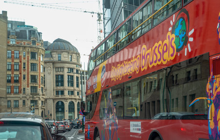Brussels, Belgium - October 12 2019: Red tourist sightseeing bus on one of the central streets.