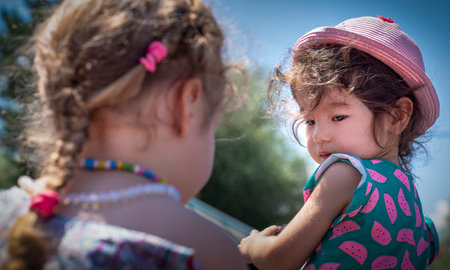 Mengen, Bolu / Turkey - August 03 2019 :  Two little girls looking each other. Communication between cute little girls.のeditorial素材
