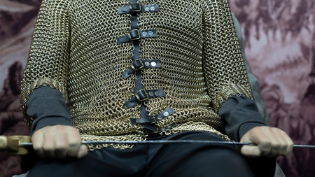 Brave warrior holding his sword and shield and sitting on the throne