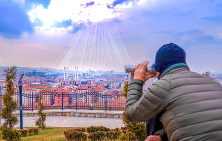 Ankara/Turkey-March 02 2019: Man watches Kocatepe Mosque thorough City binoculars
