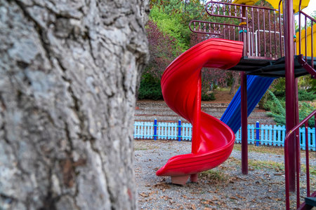 Colorful children playground activities in public park surrounded by green trees in Ankara, Turkey