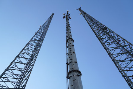 3 mobile phone base stations with blue sky background in Turkey. Competition for mobile phone users.
