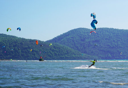 Akyaka, Mugla/Turkey-August 14 2018: Many surfers enjoying kite surfing at the beach where Azmak River meets the Mediterranean Seaのeditorial素材