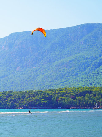 Akyaka, Mugla/Turkey-August 14 2018: A female surfer enjoying kite surfing at the beach where Azmak River meets the Mediterranean Seaのeditorial素材