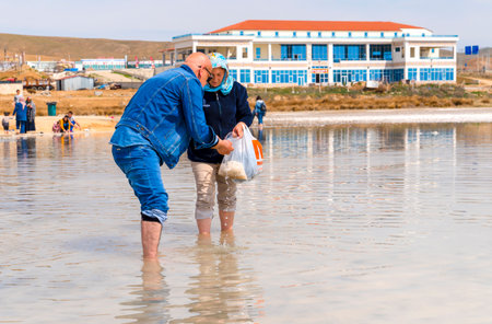 Ankara/Turkey- April 06 2019: Old Turkish couple pick salt crystal under the water in Salt Lake (Turkish: Tuz Golu)のeditorial素材