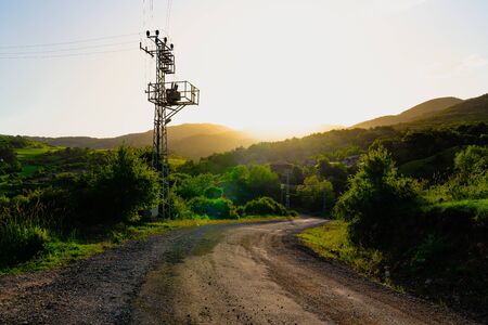 View a village in sunset with electric transformer near the road, Kizilcahamam, Ankara, Turkeyの写真素材