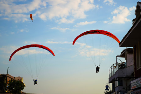 Fethiye, Mugla/Turkey - August 19 2018:  Tandem paragliders are about to land among the buildings.のeditorial素材