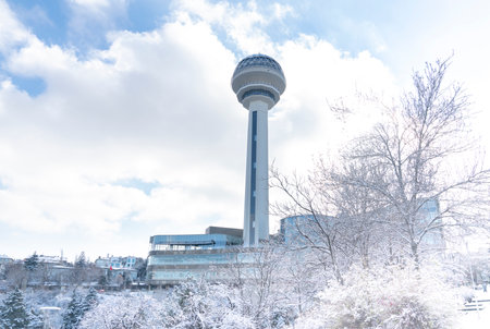 Ankara/Turkey-December 13 2018-Atakule tower and shopping mall in winter time and trees under snow in Botanic Park.のeditorial素材