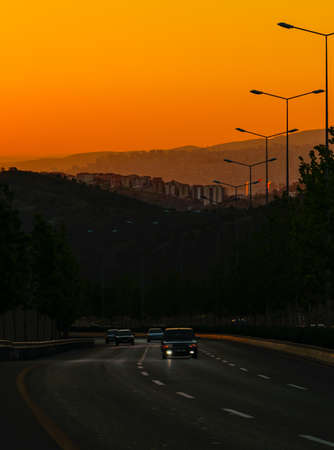 Ankara/Turkey-July 04 2020: Car on the traffic and beautiful sunset in background among hillの写真素材